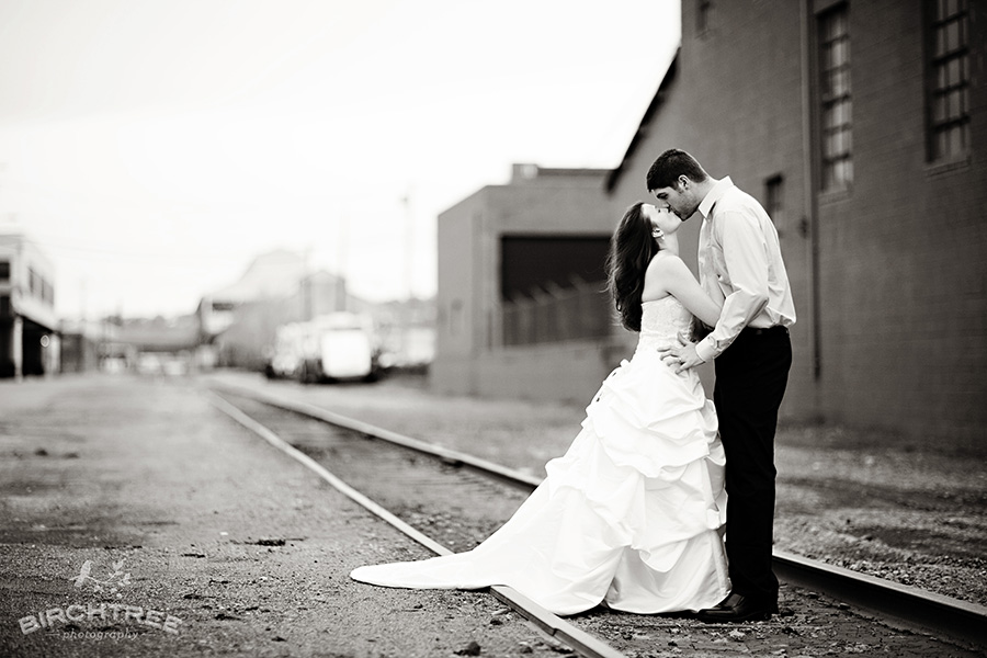 pittsburgh trash the dress photo of a couple in the strip district next to some railway lines