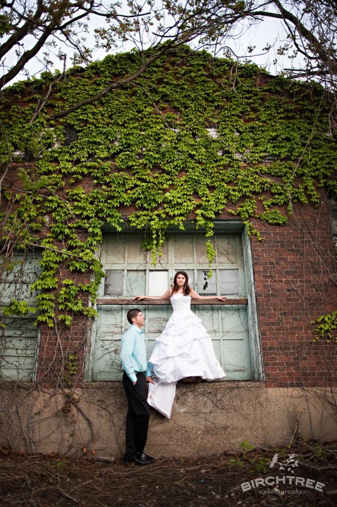 couple standing by garage door in pittsburgh strip district for post wedding photos