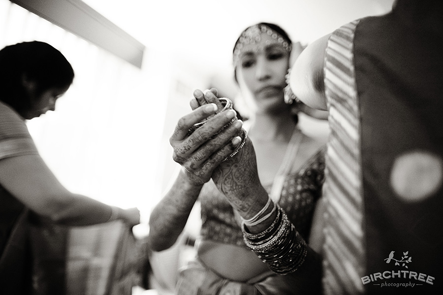 bride putting on bangles in wedding