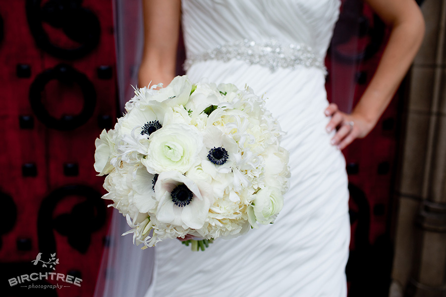 The navy blue accents really give dimension to this white bouquet